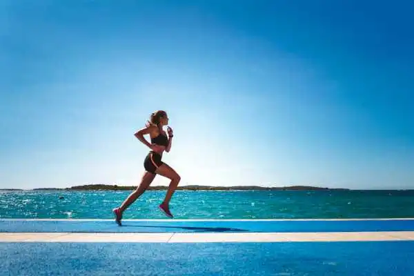 Woman running showing strong leg muscle Lyndhurst